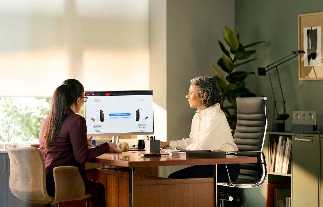 Two women lookng at a computer screen