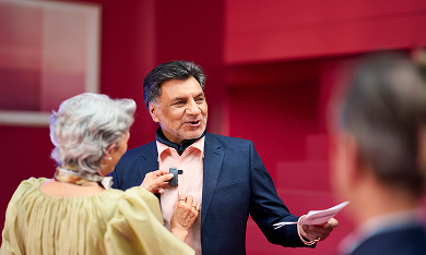 A man in a suit being fitted with a microphone